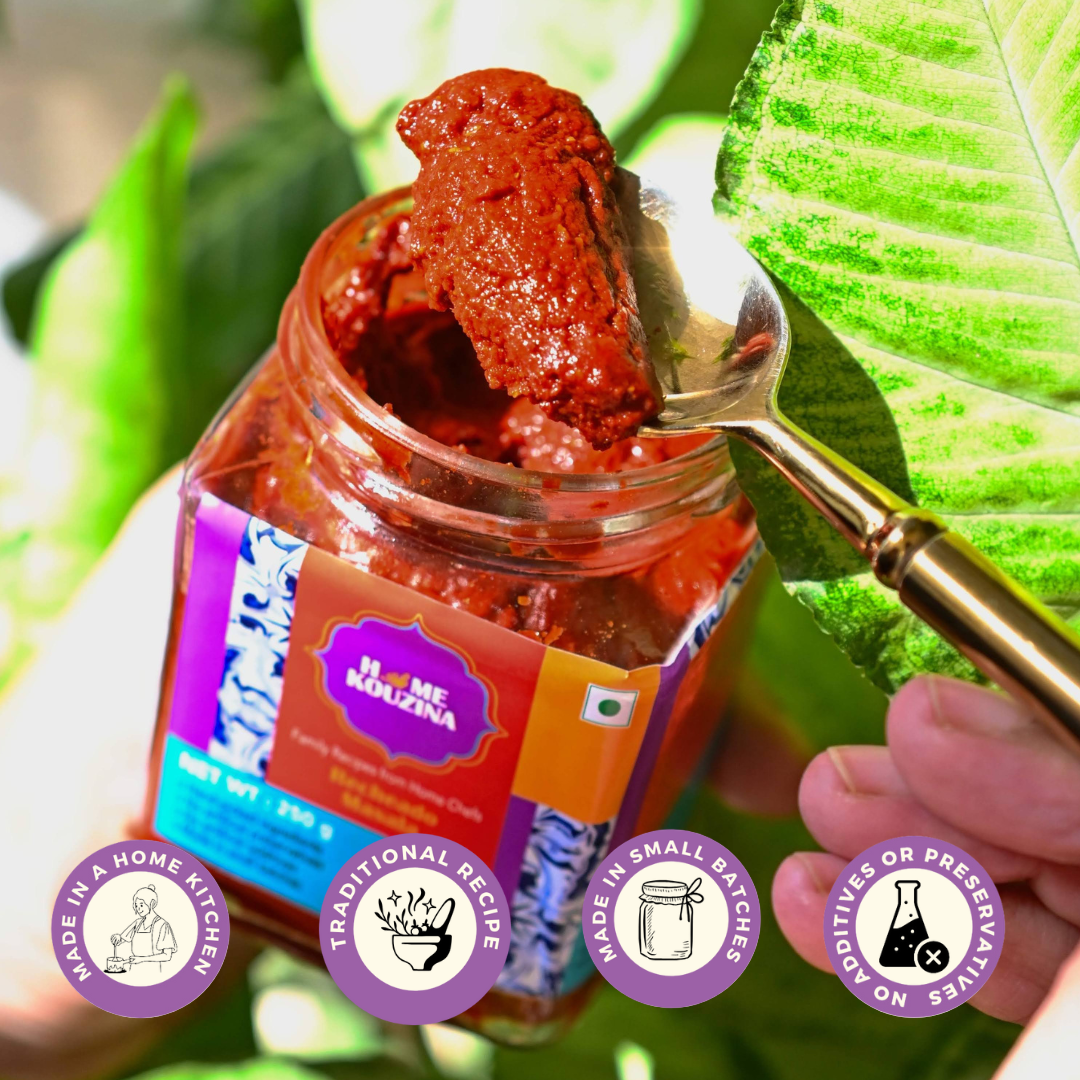 Opened Recheado Masala jar with a spoon scooping out thick, spicy paste, close-up shot