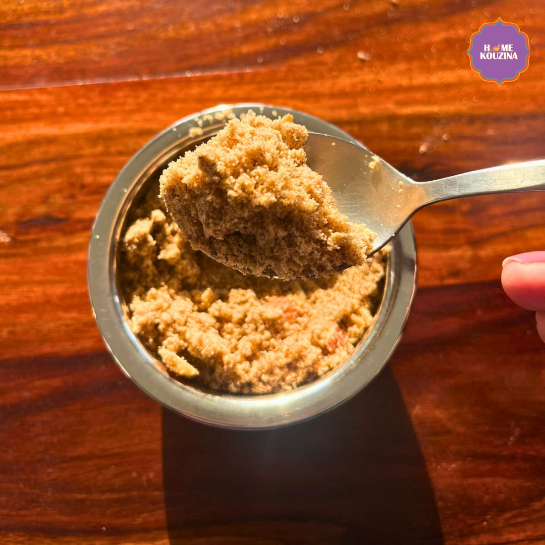 Close-up of Home Kouzina Panjiri in a bowl with a spoonful lifted, warm golden lighting highlighting the roasted texture