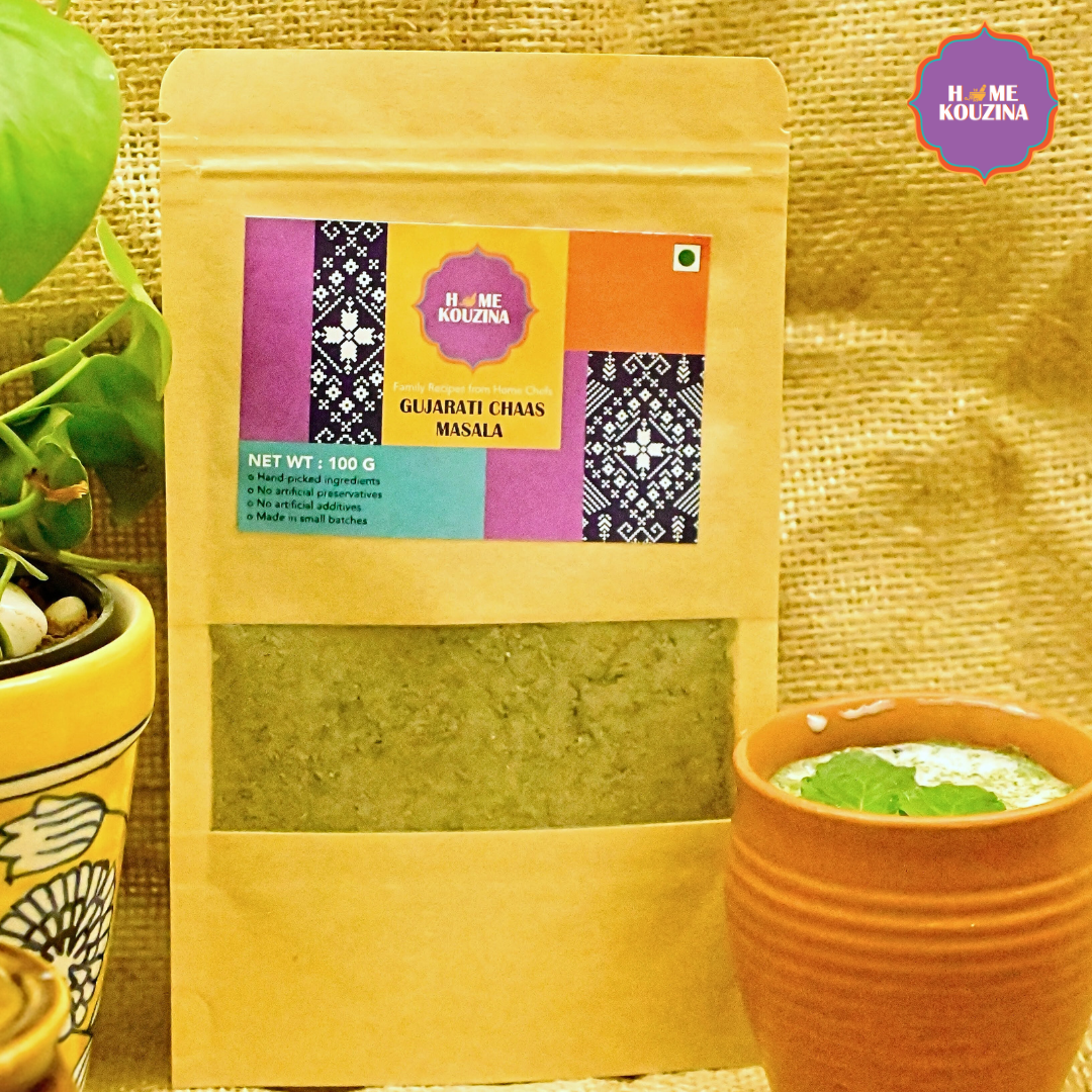 Home Kouzina Gujarati Chaas Masala 100g pouch placed next to glass of chaas – traditional Indian summer refresher