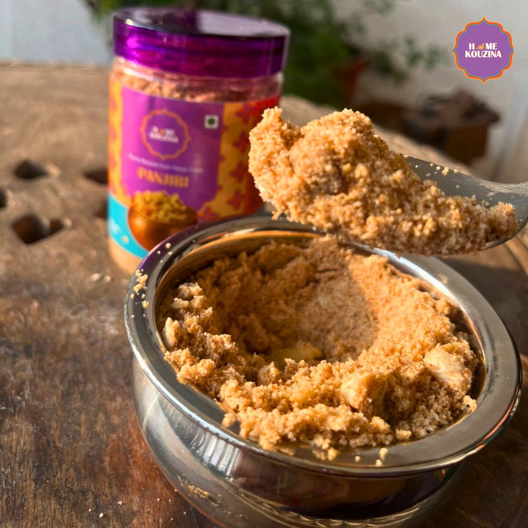 A bowl containing a spoonful of Home Kouzina's Panjiri, with Panjiri jar in the background