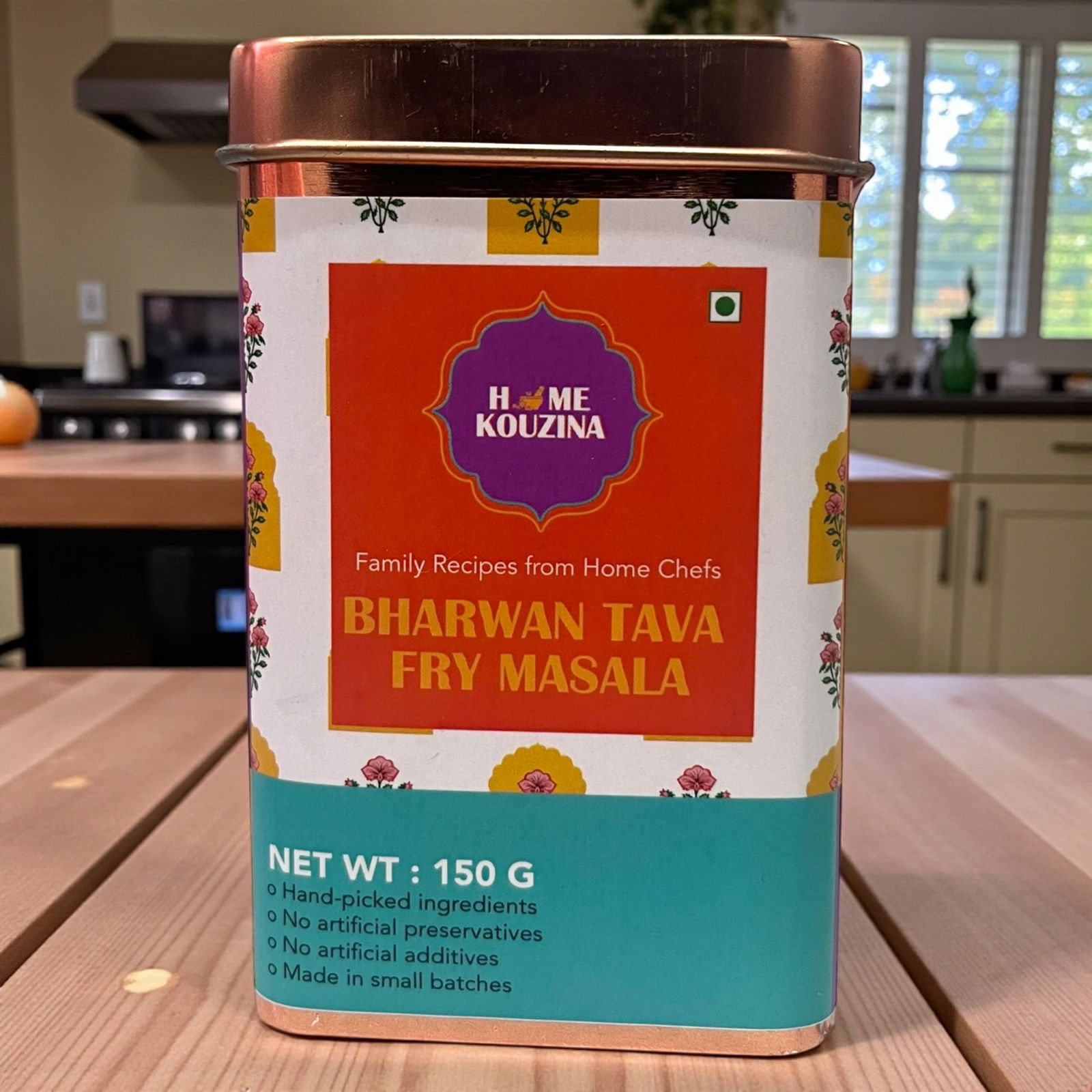 Home kouzina Bharwan Tava Fry Masala canister on a wooden surface with a kitchen background