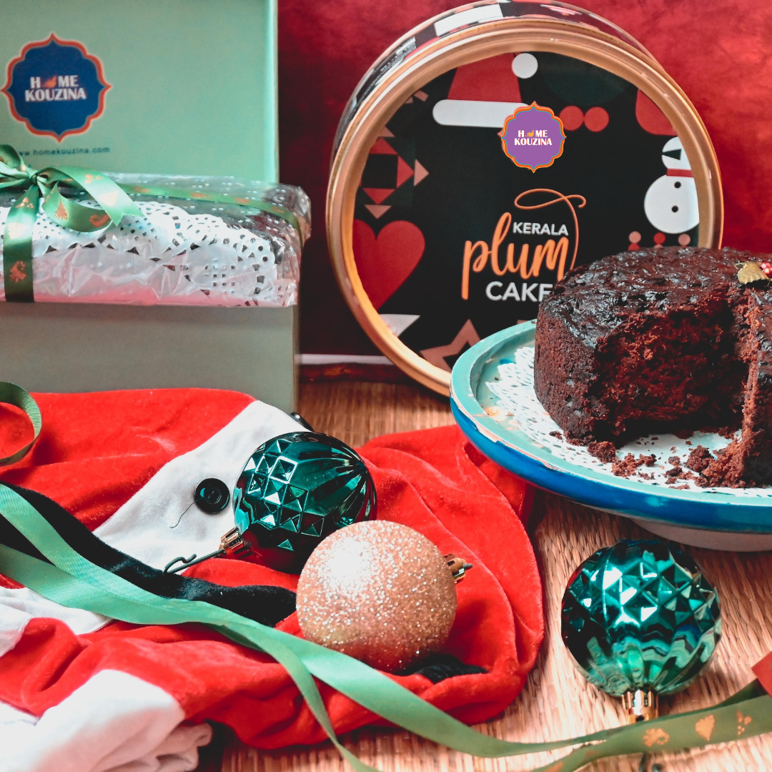 Kerala Plum Cake on a plate with Christmas decorations and a gift box in the background