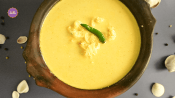  Traditional Caldine Prawns in a bowl garnished with a green chili with Home Kouzina Caldine Masala beside it.