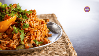 A plate of tawa pulao on a mat. 