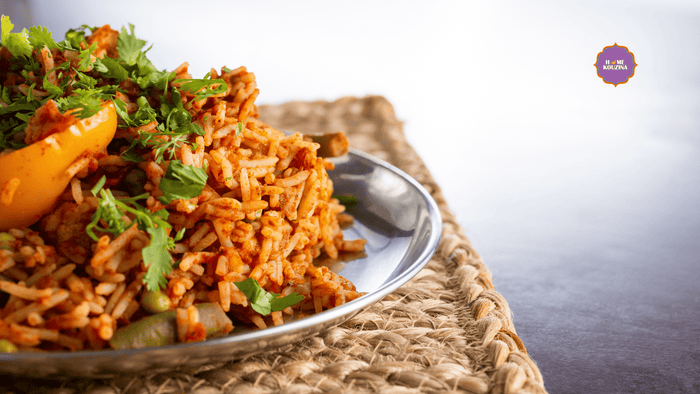 A plate of tawa pulao on a mat. 