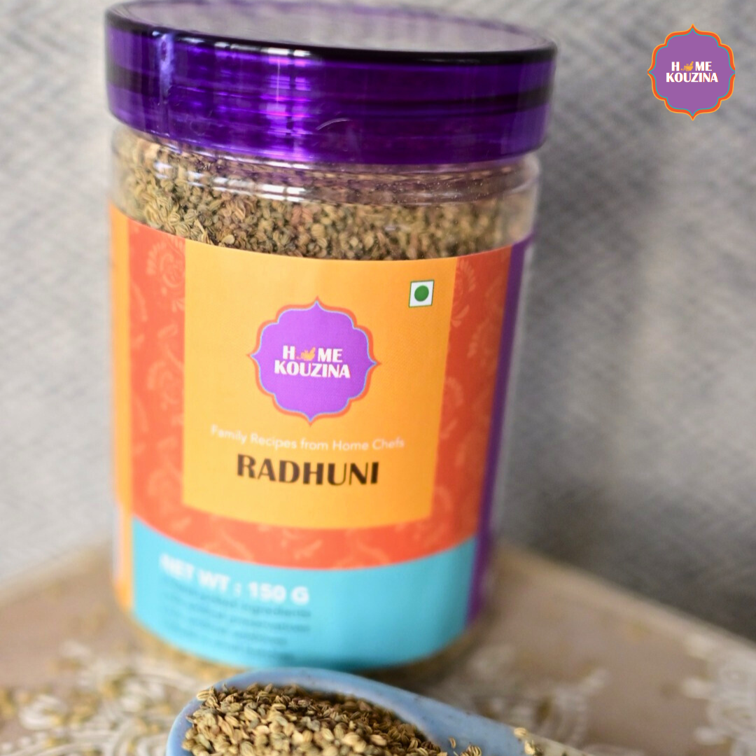 Jar of 'Radhuni' spice mix with a purple lid and colorful label on a neutral background.