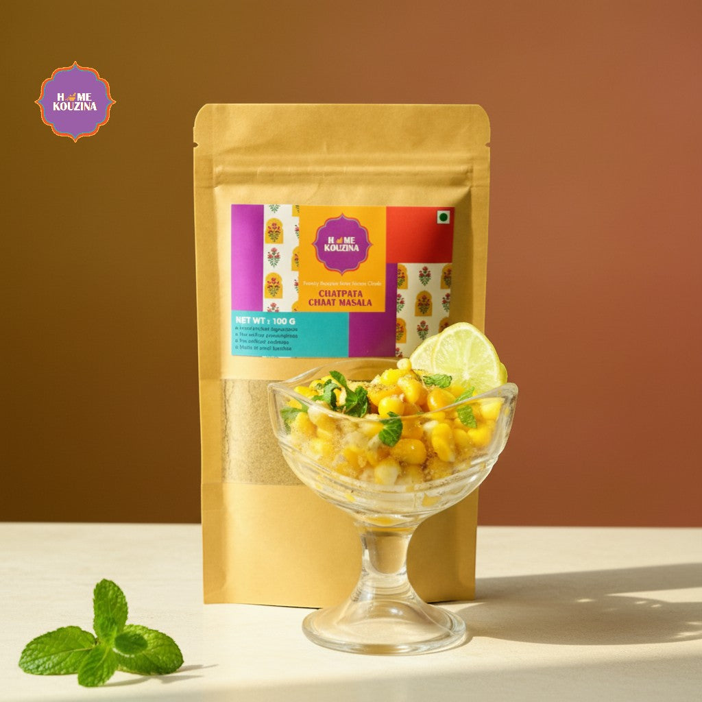 Chat masala package with a glass bowl of chutney and lime on a brown background
