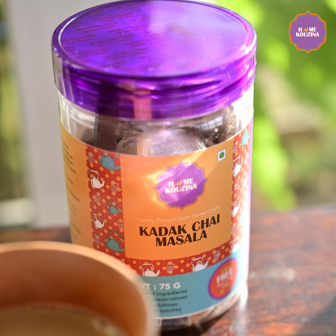 Jar of Kadak Chai Masala with a purple lid on a blurred background