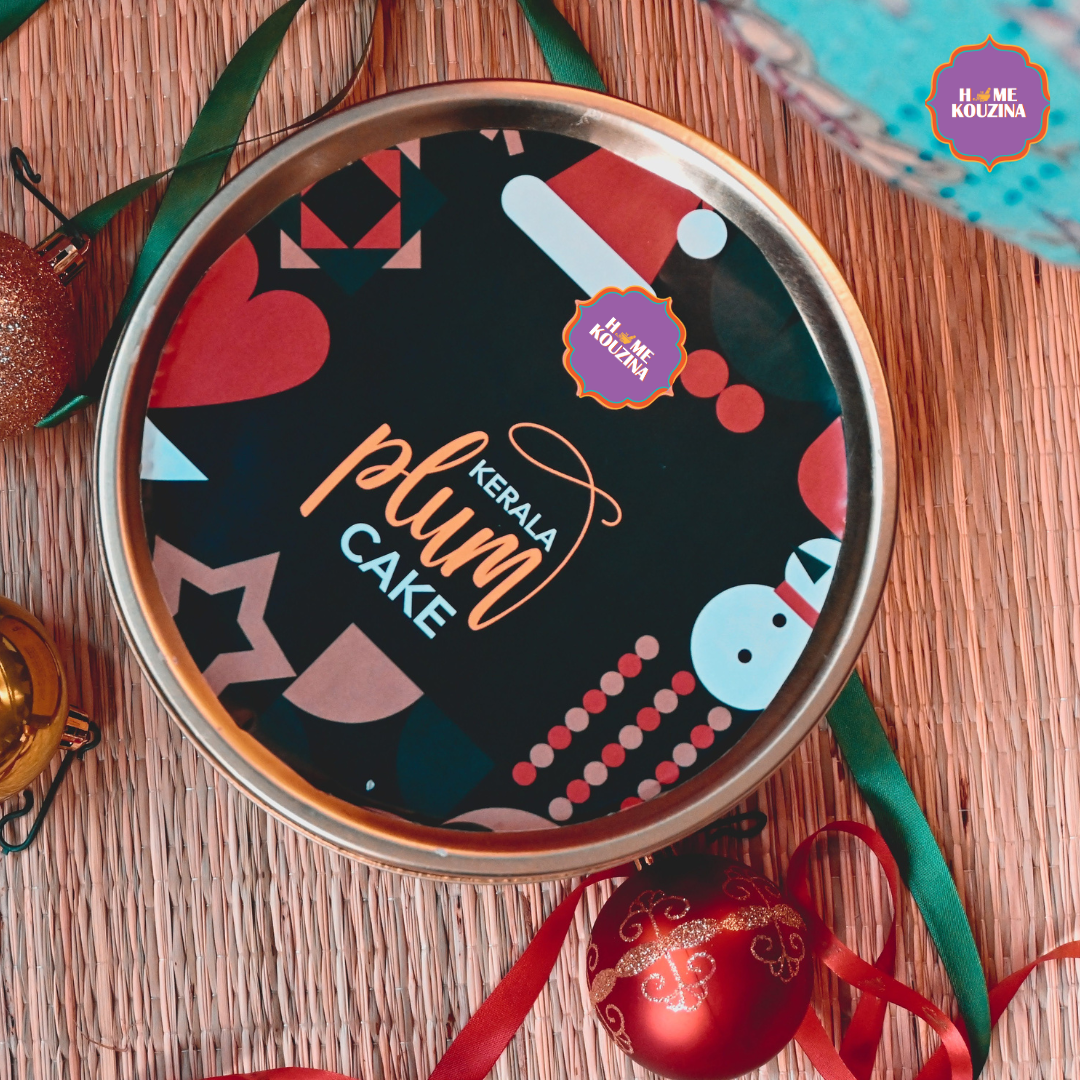 Plum cake tin with colorful design on a wooden surface